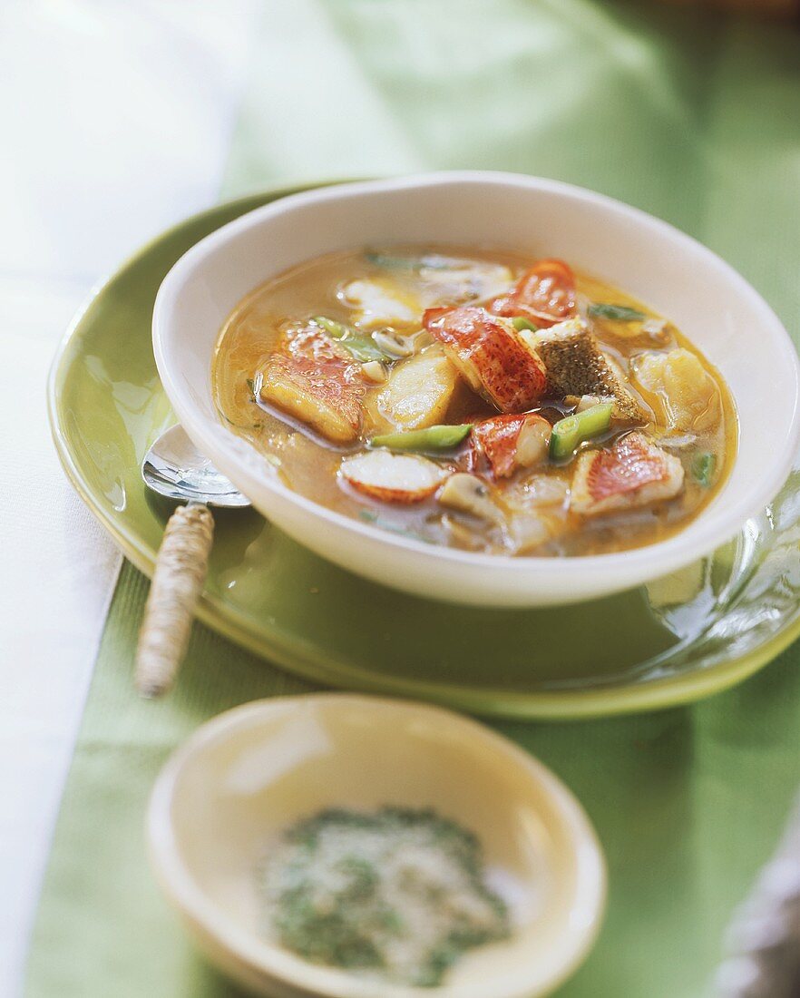 Fish soup with lobster tails and mangetouts