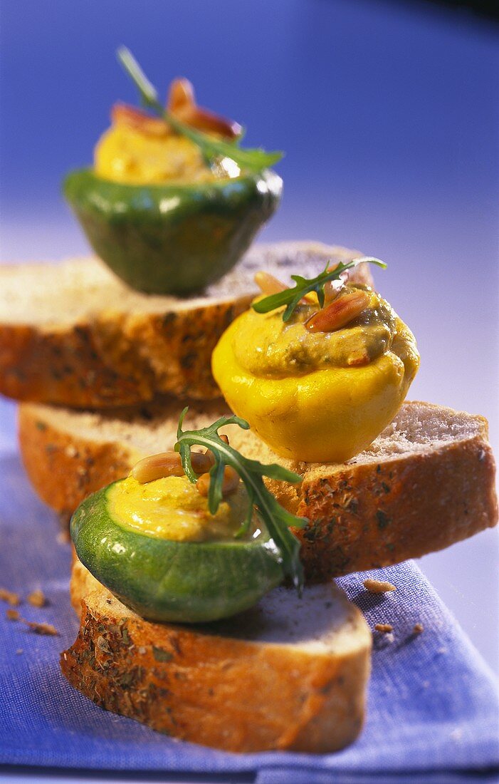 Mini-pumpkins with spicy stuffing on slices of bread