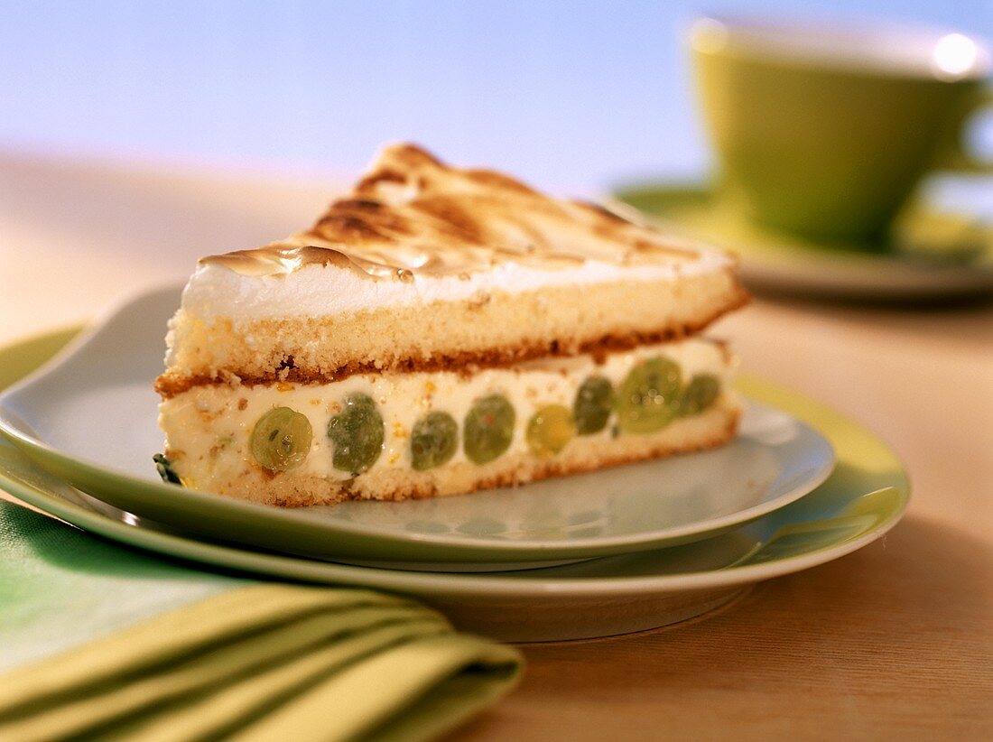 Piece of yoghurt meringue cake with gooseberries