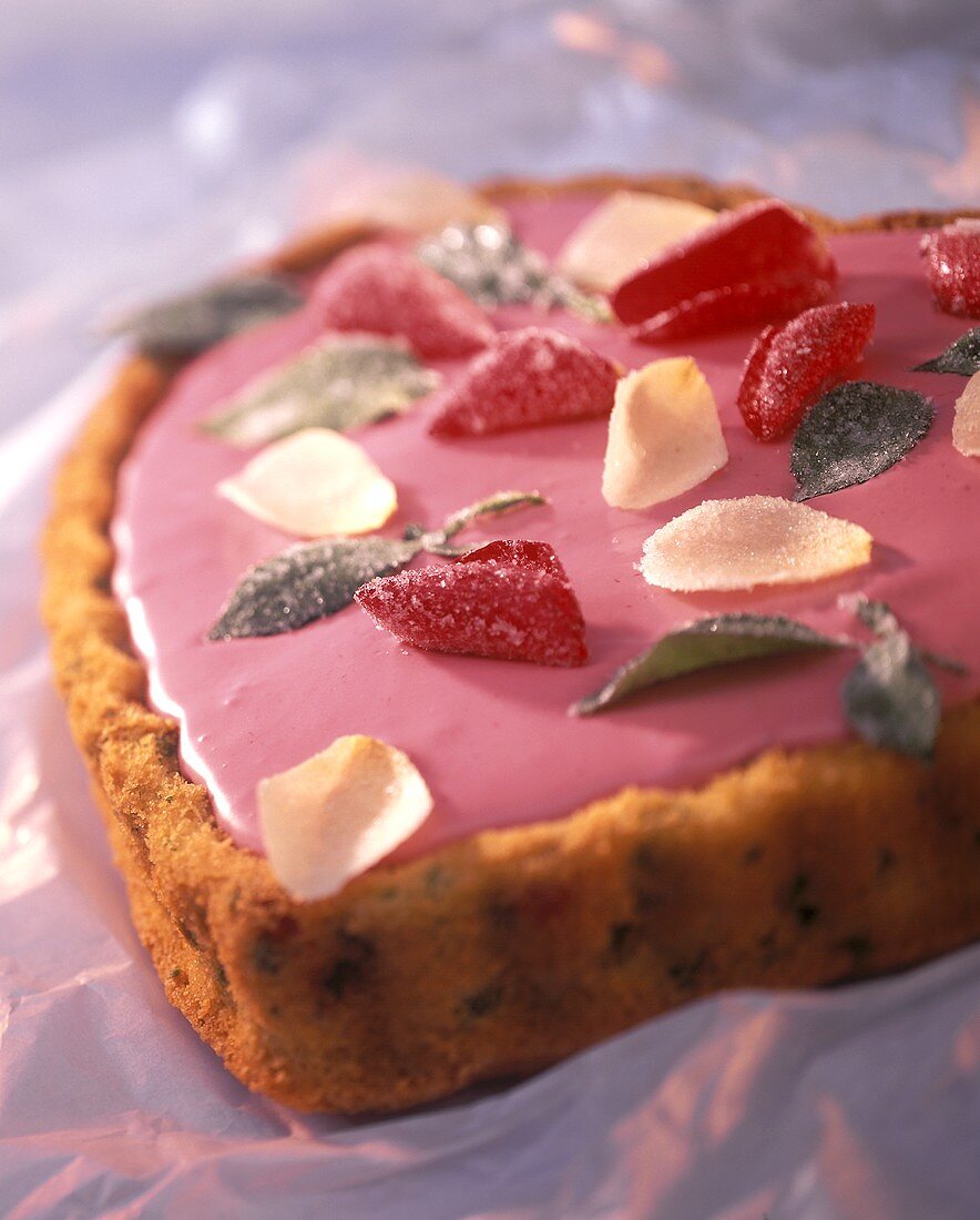 Love cake with pink icing and sugared flowers