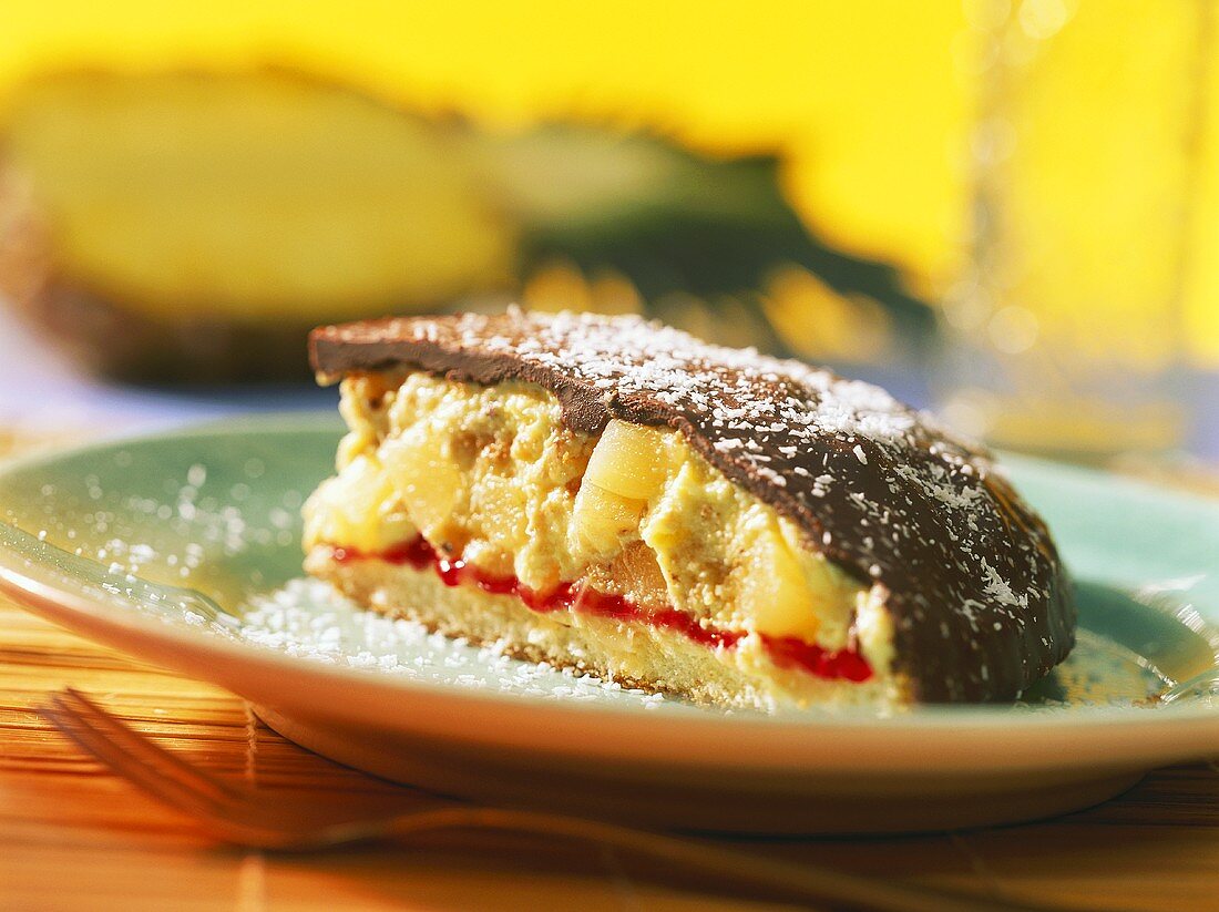 Piece of pineapple rum bombe with coconut flakes