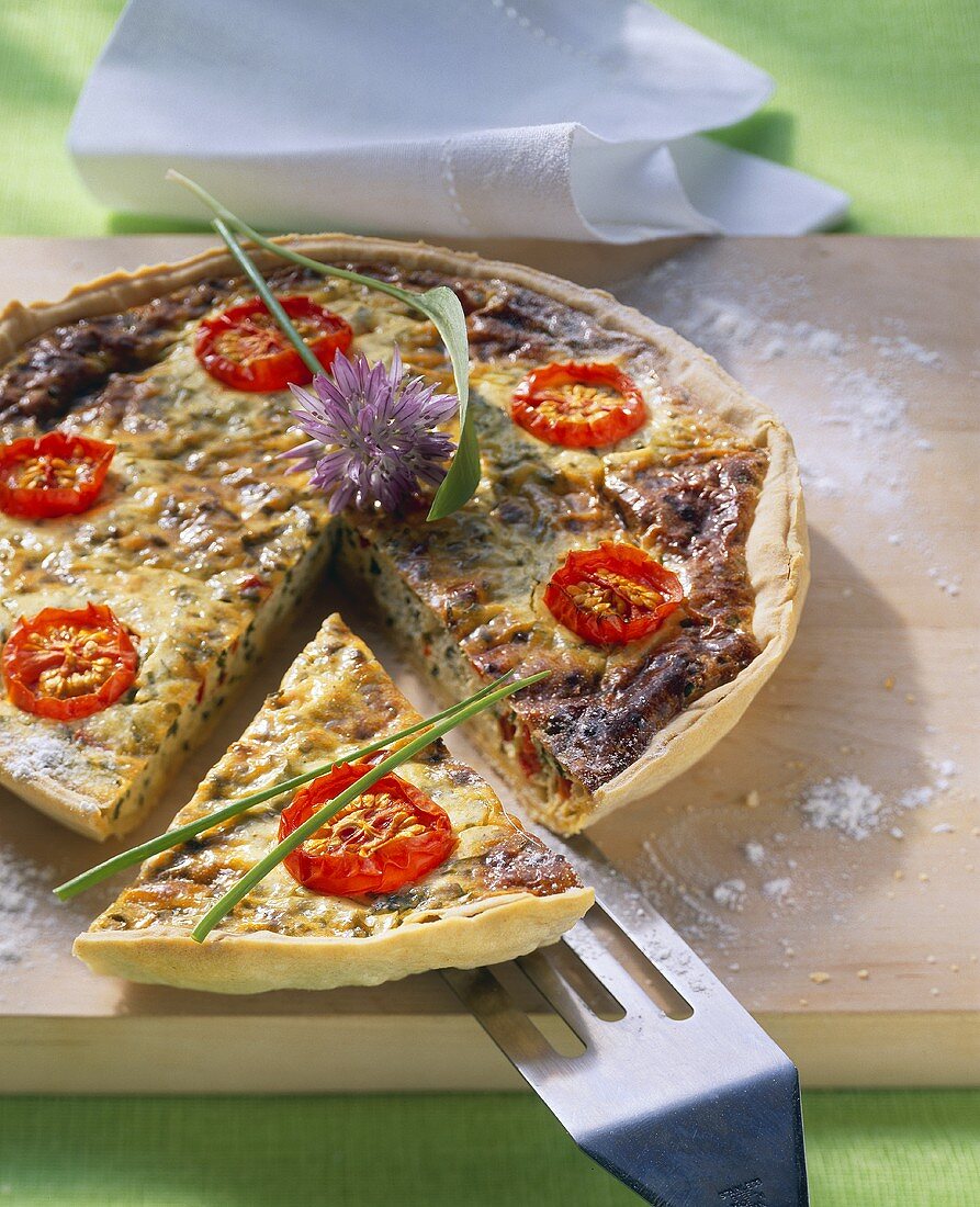 Ramsons (wild garlic) quiche with cherry tomatoes (piece cut)