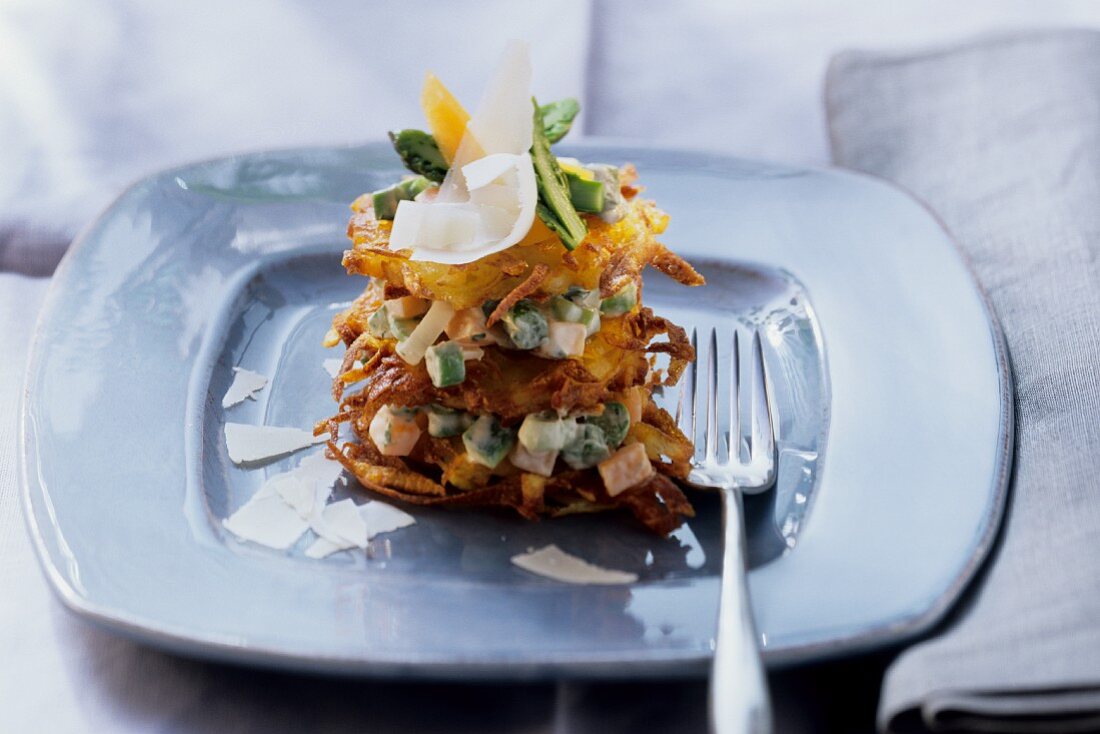 Rosti tower with vegetables and Parmesan shavings