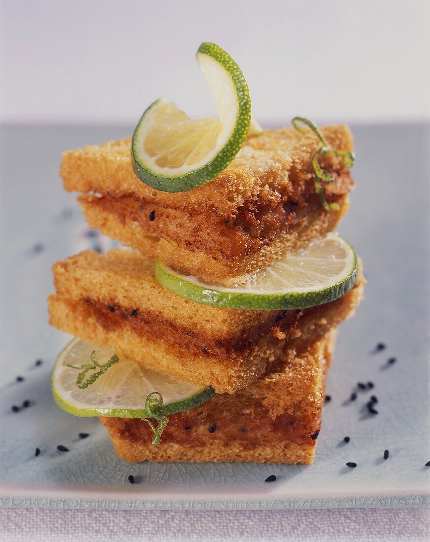 Fried bread triangles with shrimp puree and lime slices