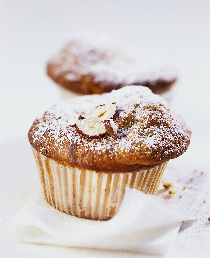 Banana muffins with hazelnuts and icing sugar