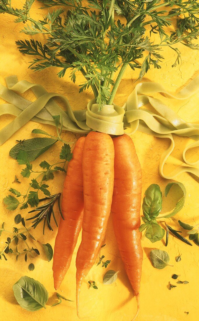 Carrots, green ribbon noodles and fresh herbs