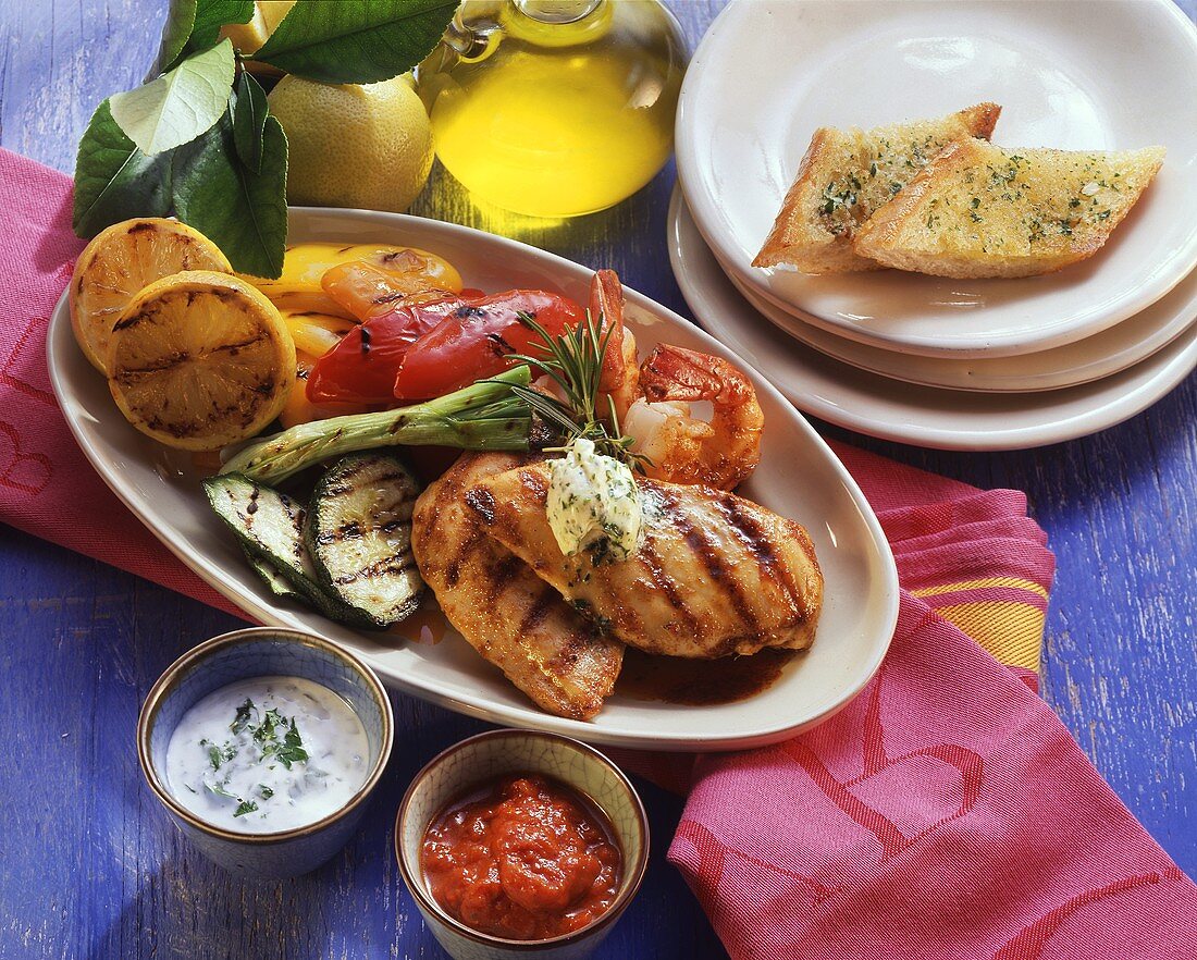 Chicken breast & shrimps with vegetables, baguette & dips