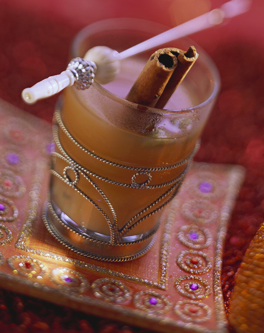 Indian spiced tea with cinnamon stick in glass