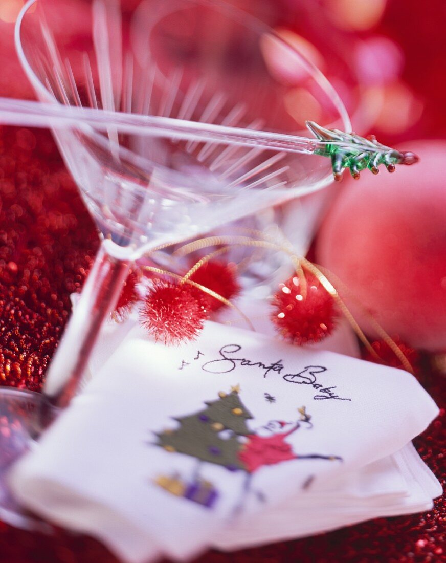 Cocktail glass and napkin with inscription Santa Baby