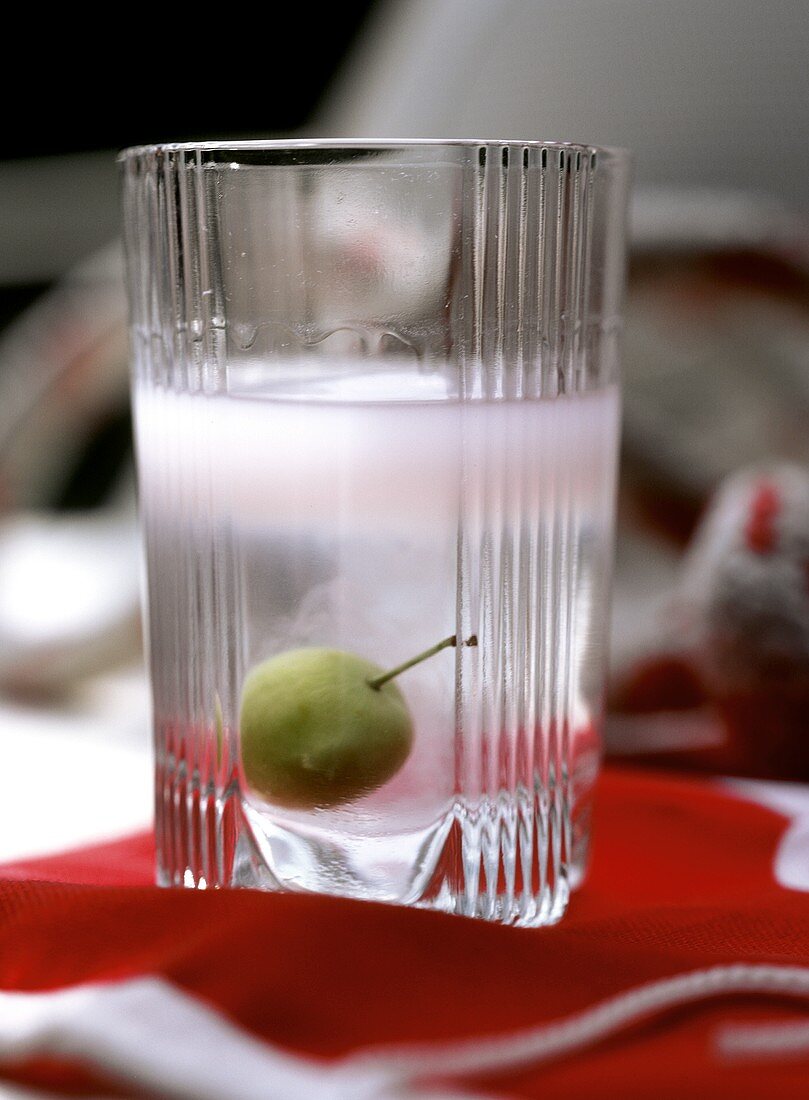 Raki with olive in glass