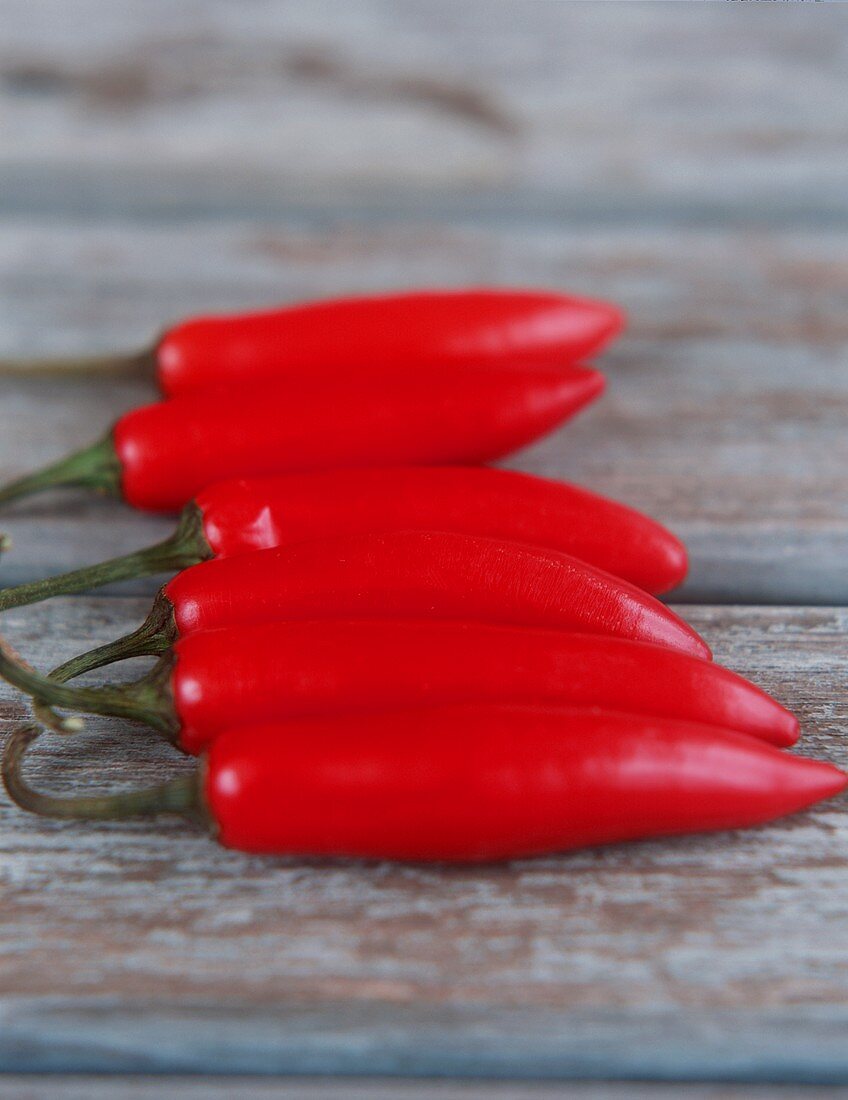 Red chili peppers on wooden background