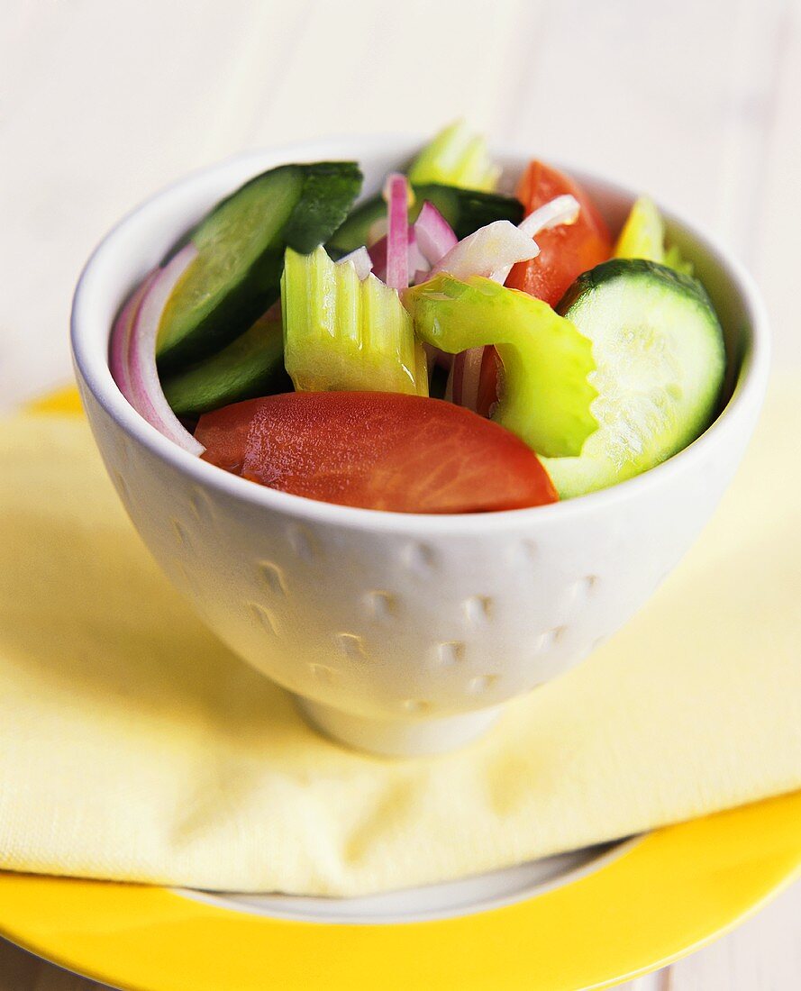 Raw vegetable salad in white bowls