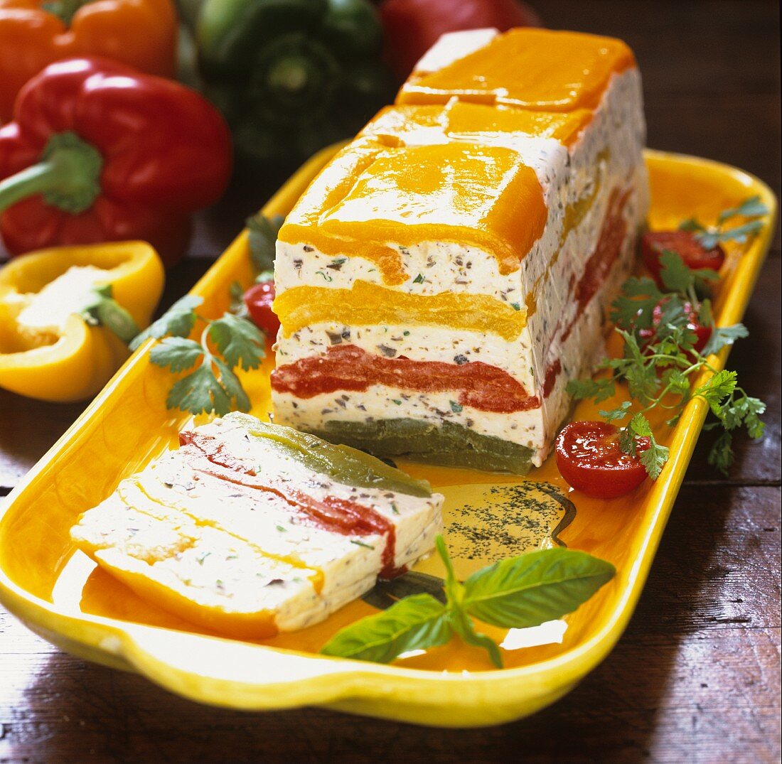 Pepper and goat's cheese terrine on yellow platter
