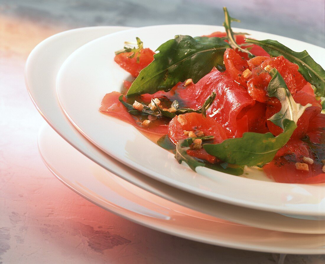 Tuna carpaccio with grilled tomatoes and rocket