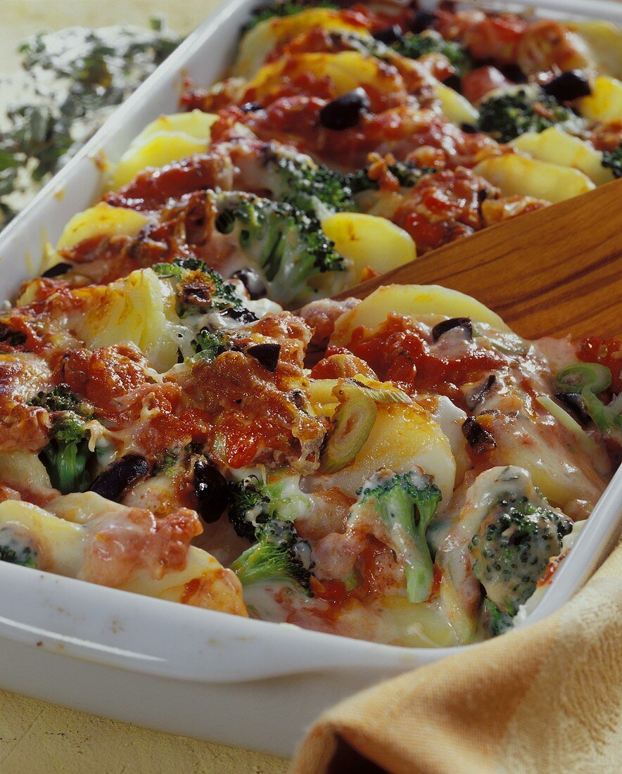 Potato gratin nicoise with tomatoes, broccoli & olives