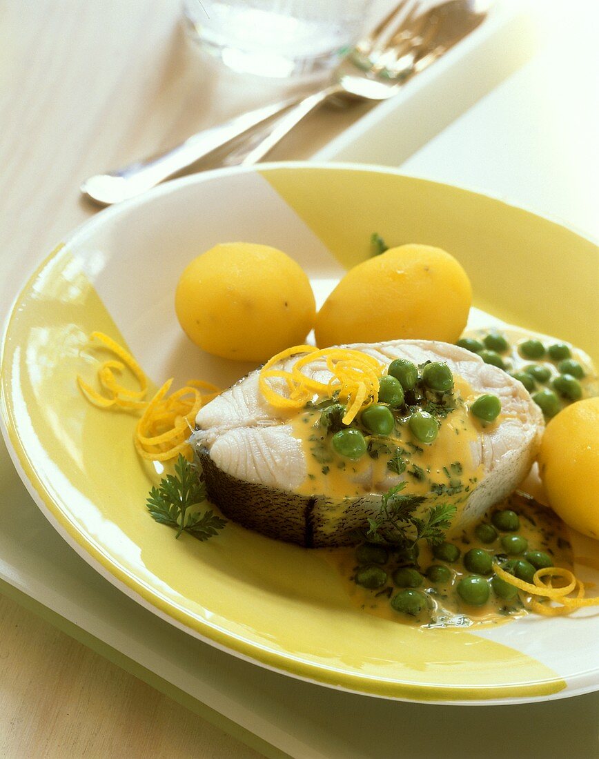 Fish cutlets in pea & lemon butter with potatoes in their skins
