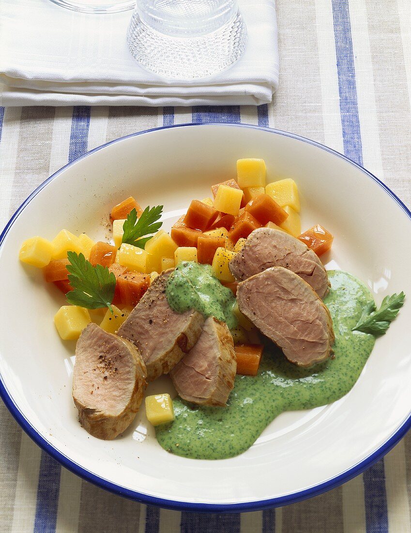 Pork fillet with parsley sauce and diced vegetables
