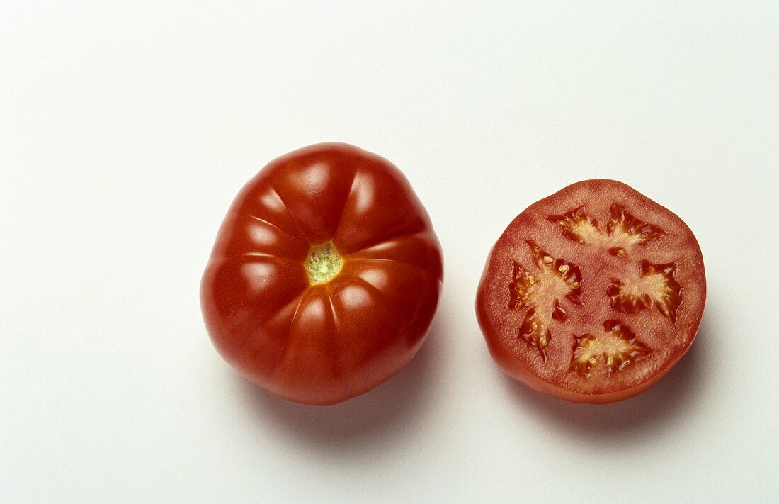 Whole and half beefsteak tomato