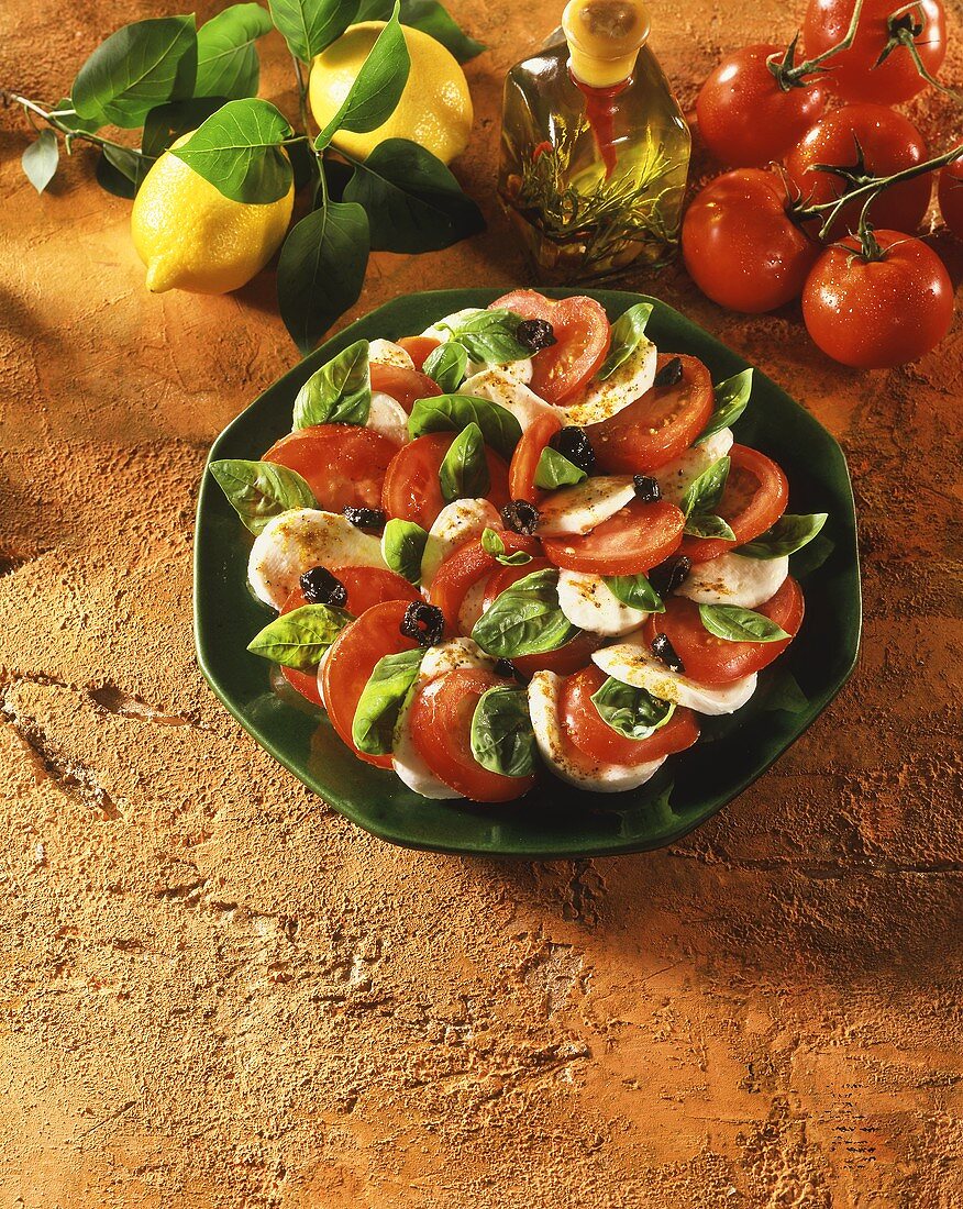 Tomato and mozzarella salad with basil and olives