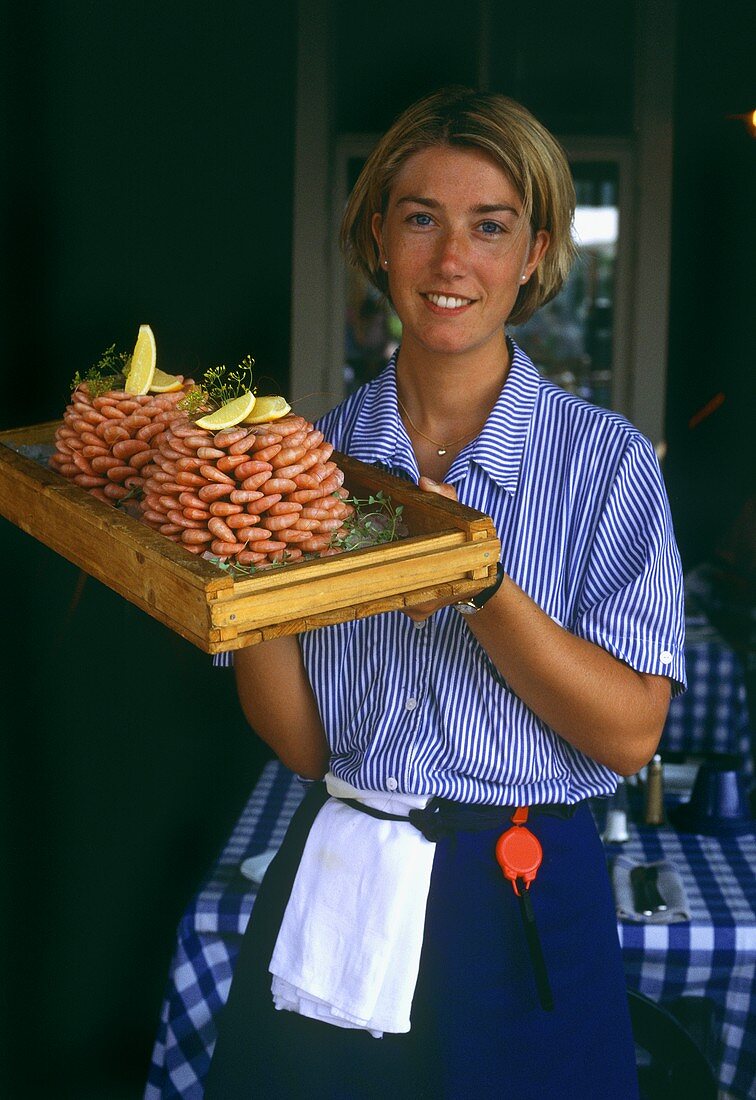 Swedish waitress holding tray of shrimps