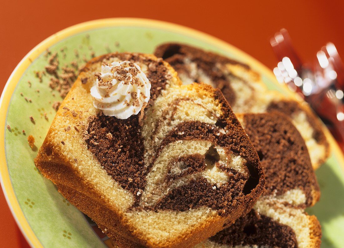 Slices of marble cake with blobs of cream