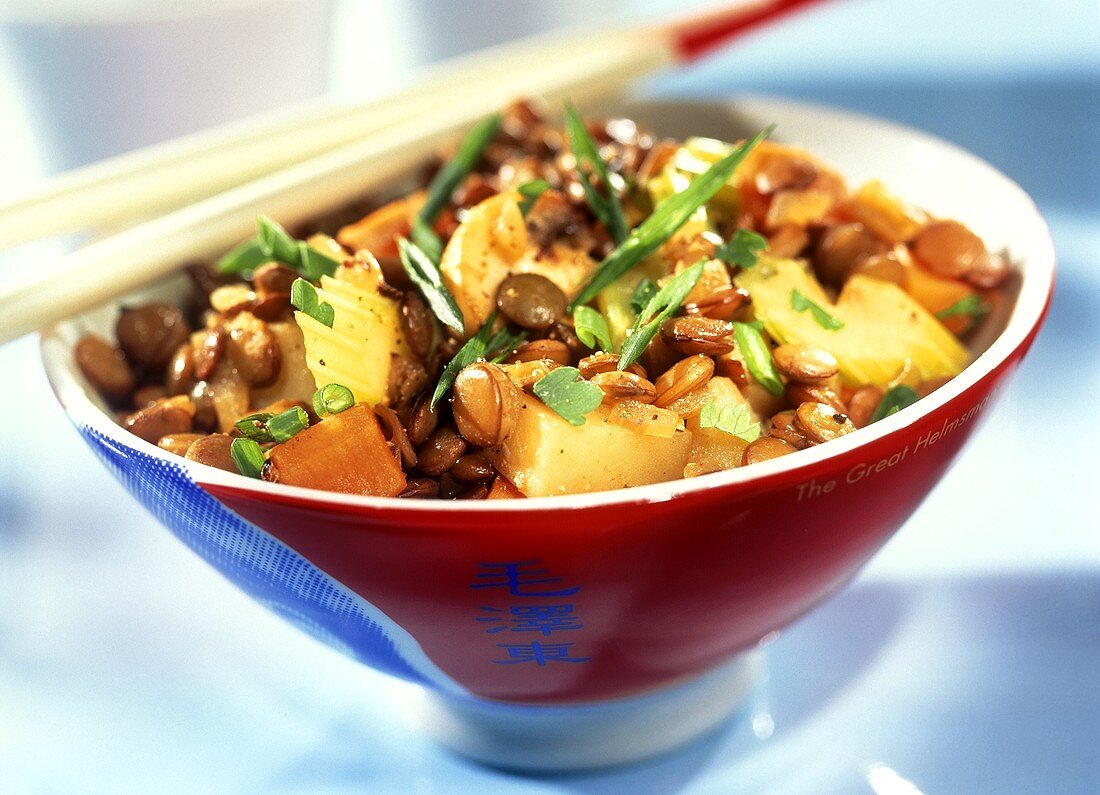 Asian lentil stir-fry with potatoes, carrots and herbs