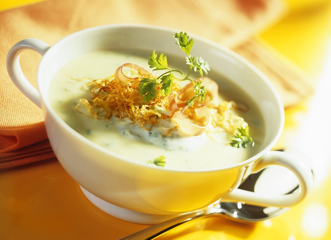 Cream of potato soup with sauerkraut, ham and herbs