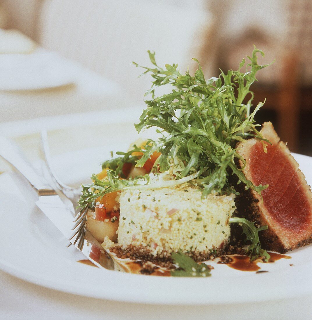 Pink fried tuna with couscous and salad