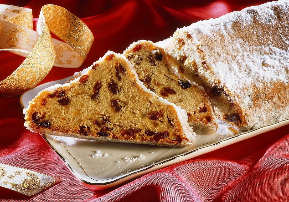 Christmas stollen, pieces cut, on cake plate
