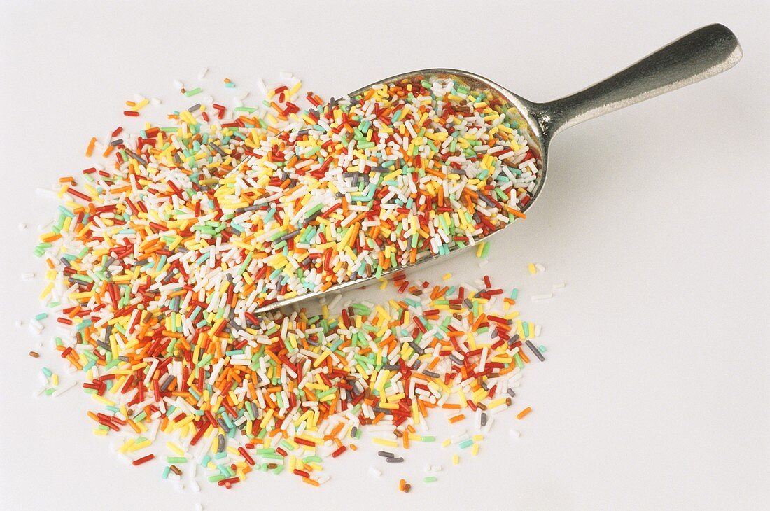 Coloured sprinkles, partly on scoop