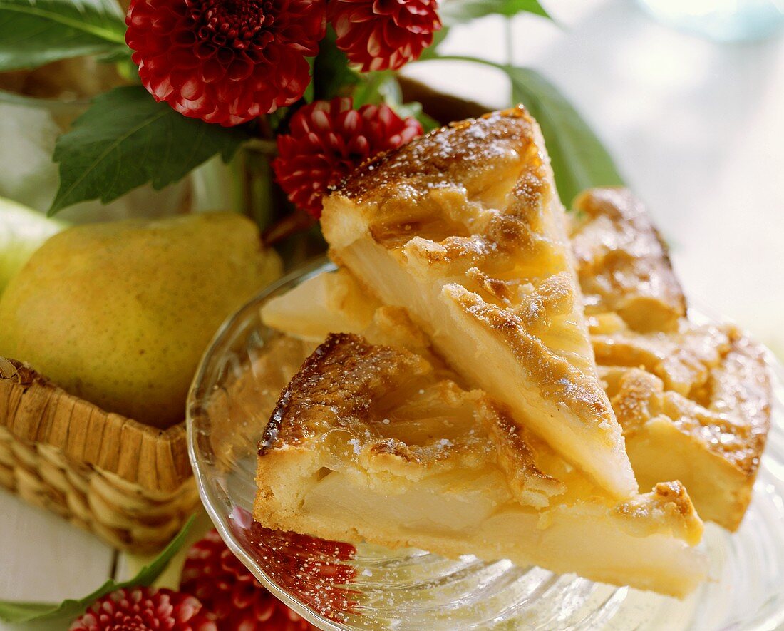 A few pieces of tipsy pear tart on glass plate