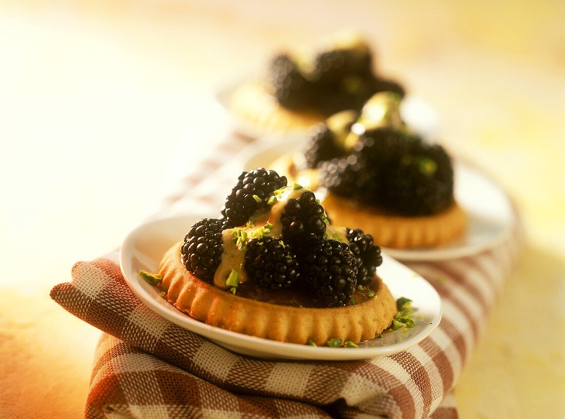 Blackberry tartlets with balsamic whip and pistachios