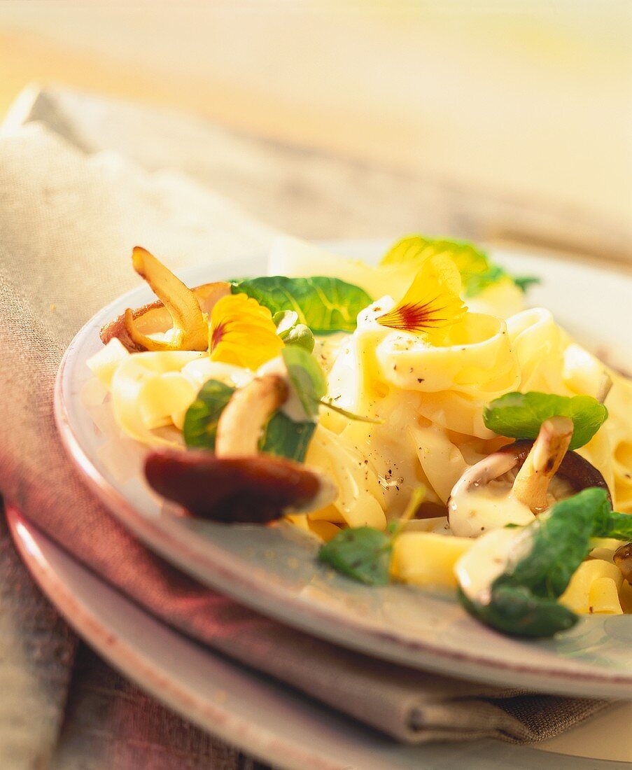 Tagliatelle with Asian vegetables, cream sauce & edible flowers