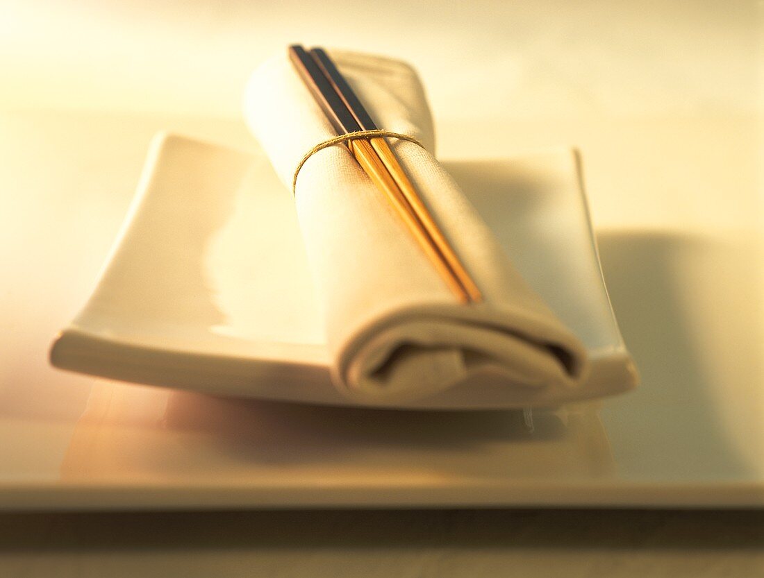 Napkin with chopsticks on Asian plate