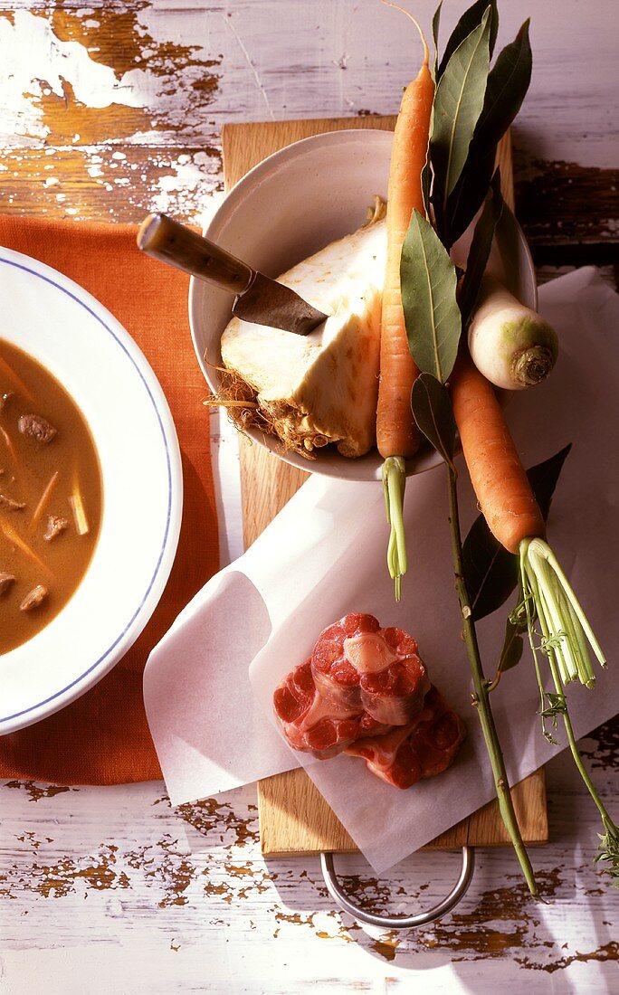 Goulash soup with ingredients (vegetables, meat, bay leaf)
