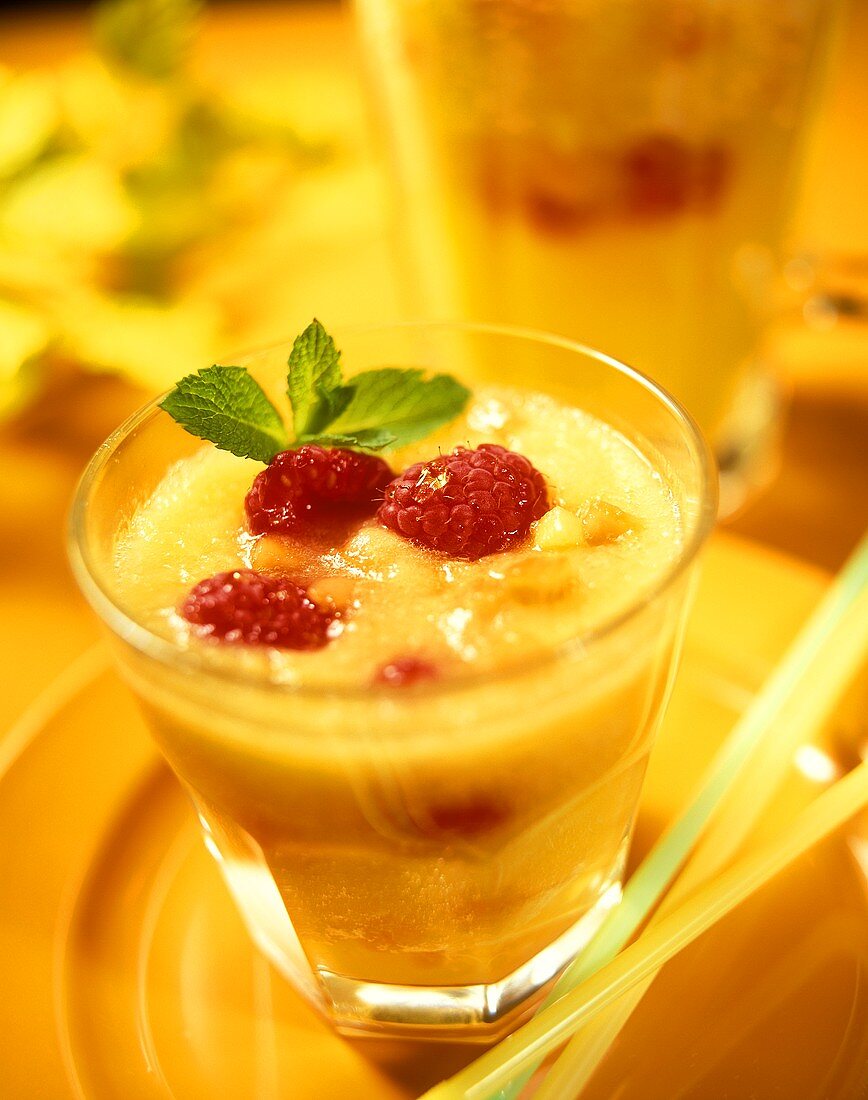 Pineapple, mango and papaya punch with raspberries