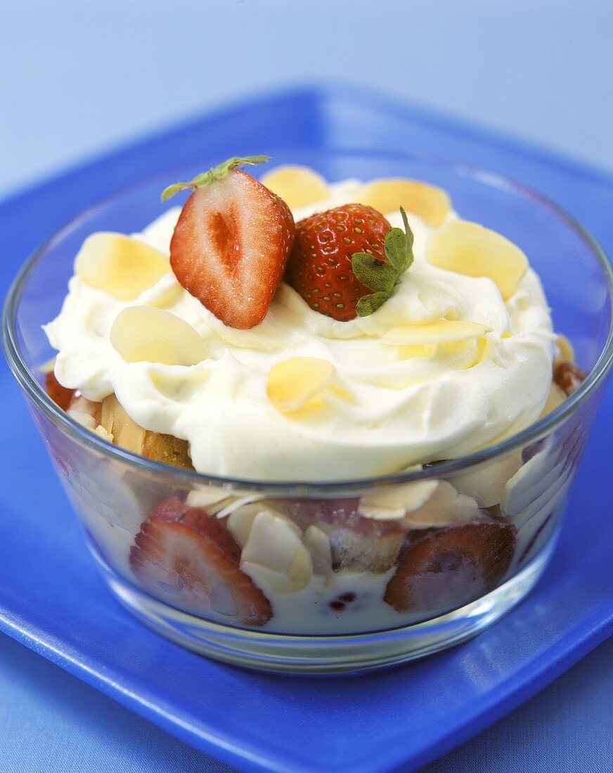 Strawberry trifle with cream and flaked almonds