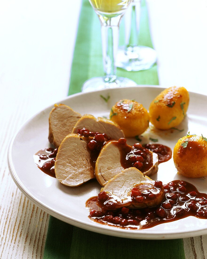 Pork fillets with cranberry sauce and roast potatoes