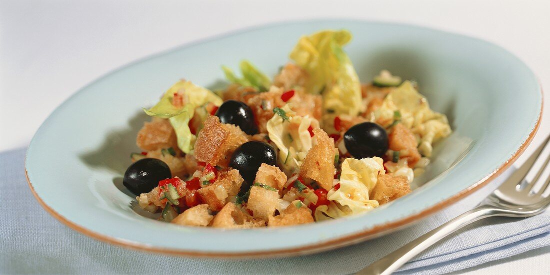 Bread salad with black olives and pepper flakes