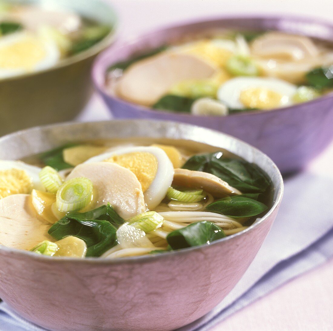 Japanese noodle soup with chicken, egg and spinach