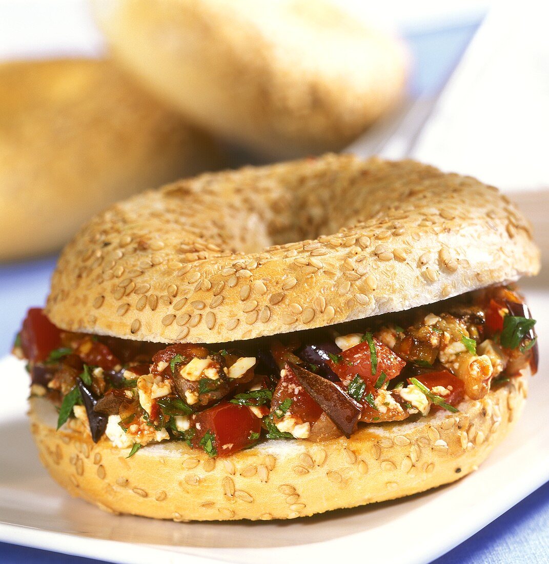 Sesame ring with aubergine and tomato salad