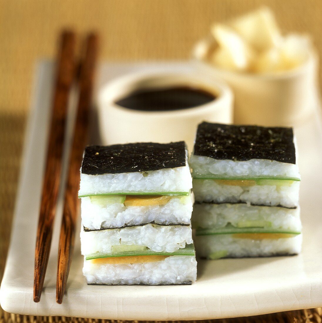 Maki sushi squares with soy sauce as party snacks