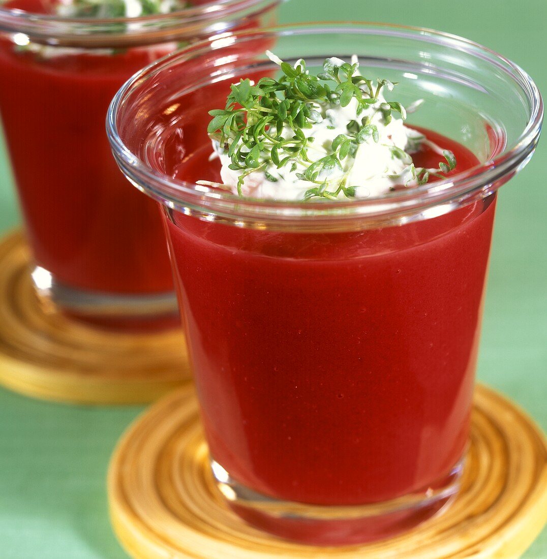 Spicy beetroot soup with cress cream in glasses