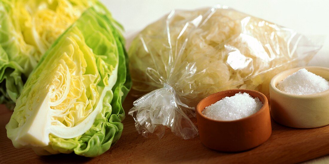 Still life with white cabbage, sauerkraut, salt and sugar