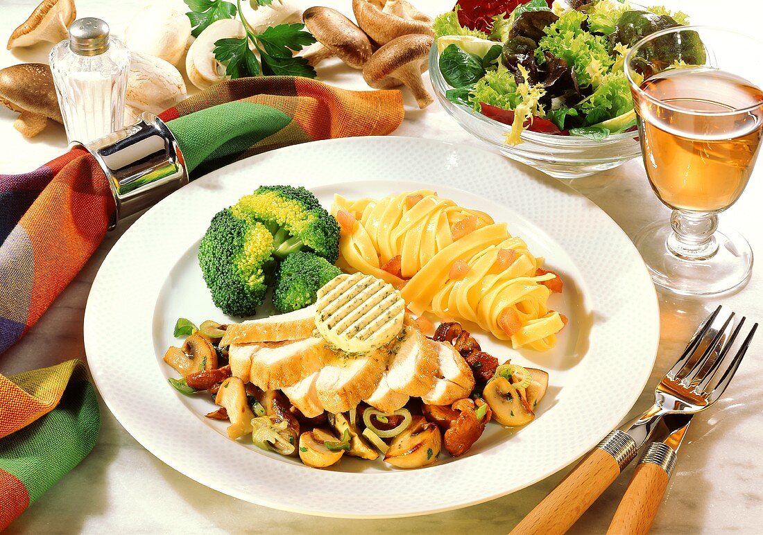 Chicken breast with mushroom ragout, noodles, broccoli & salad