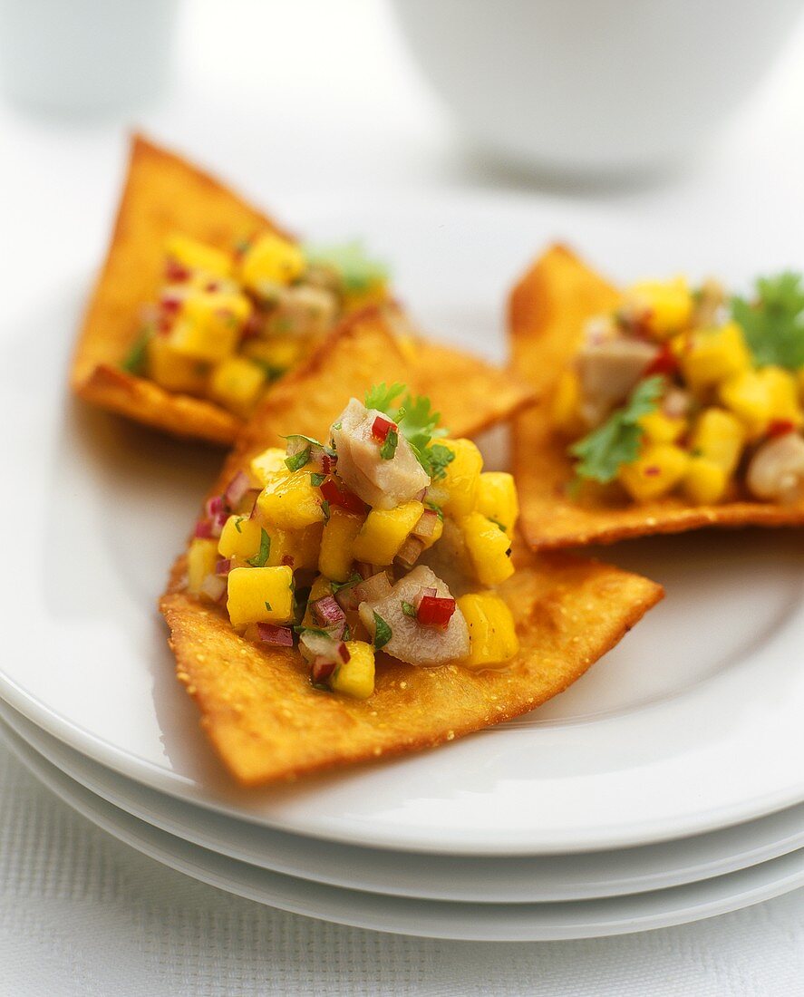 Marinated tuna with mango salsa on tortilla chips