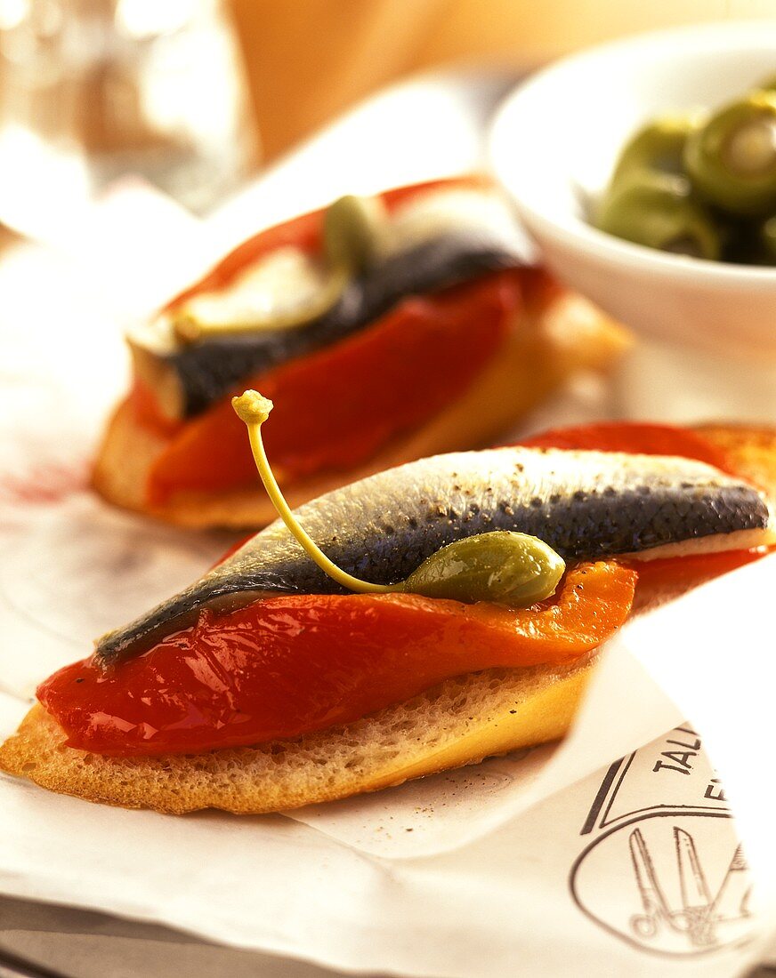 Bread topped with sardines, capers and peppers (tapas)