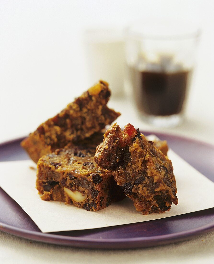 Three pieces of fruit cake in pieces on plate