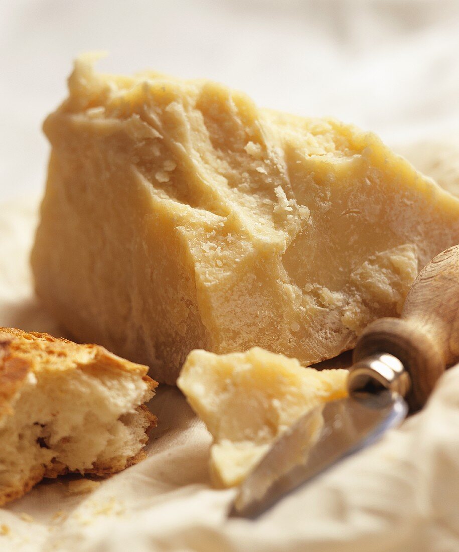 Parmesan with cheese knife and white bread