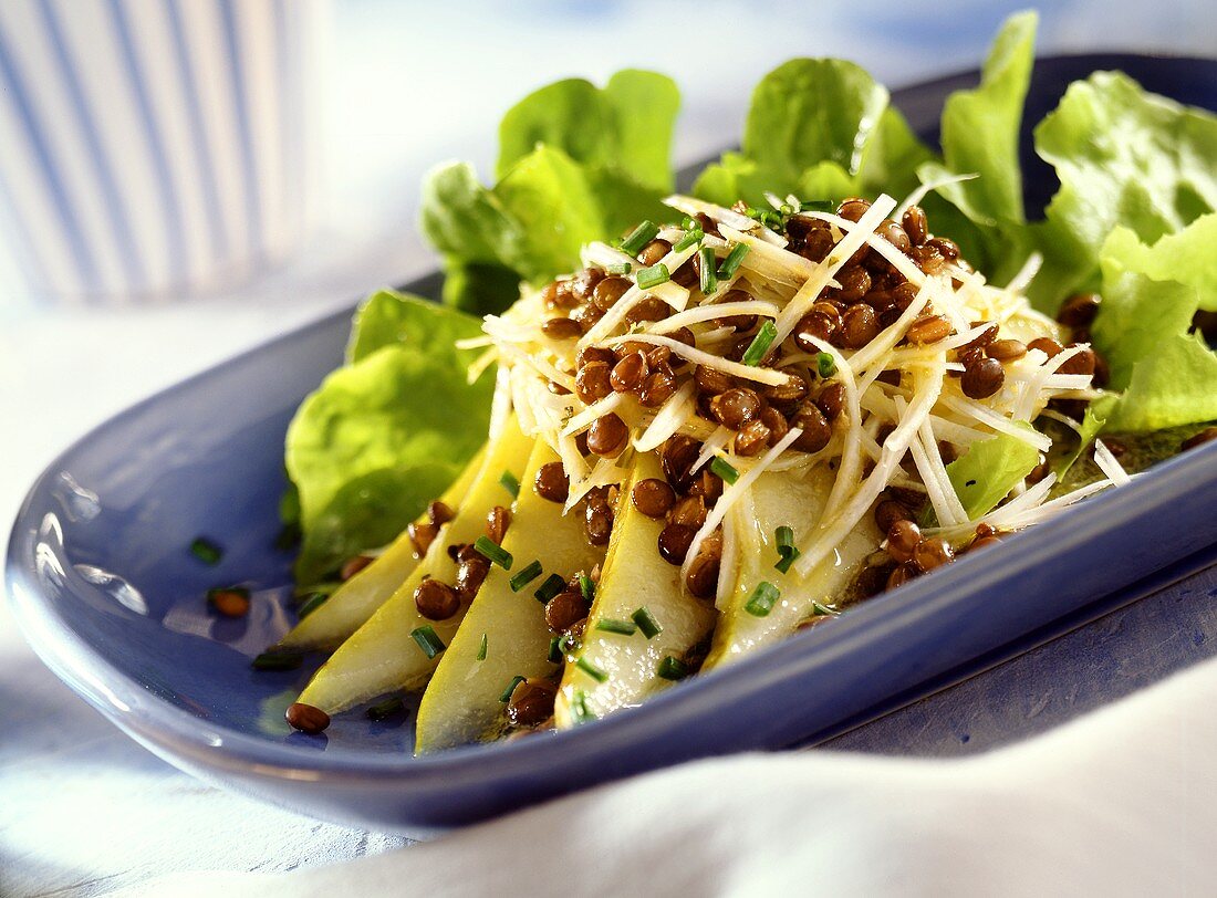 Lentils on raw celery salad with slices of pear